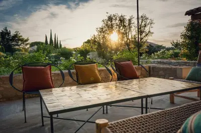 a group of chairs and a table on a patio at Mas Au pays des Alpilles in Eygalières