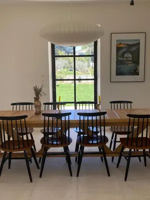 a dining room with a wooden table and chairs at Mas Au pays des Alpilles in Eygalières