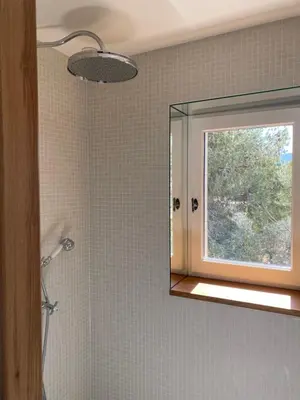 a bathroom with a mirror and a window at Mas Au pays des Alpilles in Eygalières