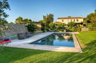 a swimming pool in the yard of a house at Mas Au pays des Alpilles in Eygalières