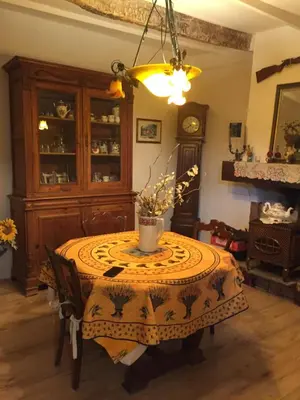 a dining room with a table with a vase on it at Maison de village provençale in Monieux