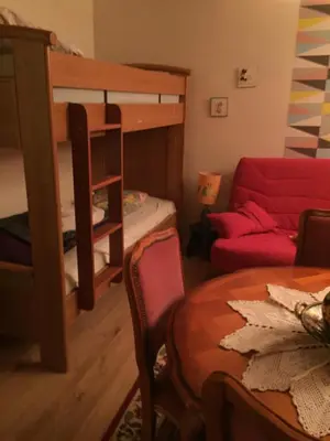 a living room with a bunk bed and a table at Maison de village provençale in Monieux