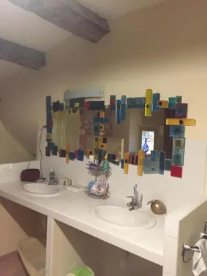 a bathroom with two sinks and a lego wall at Maison de village provençale in Monieux