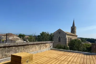 a wooden box on the roof of a church at Limasola - Apartment and its rooftop in Les Vignères