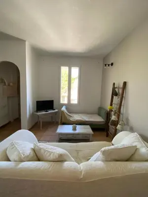 a living room with two beds and a couch at Limasola - Apartment and its rooftop in Les Vignères