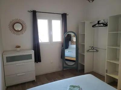 a bedroom with a mirror and a dressing room at Maisonnette au cœur de Lauris in Lauris