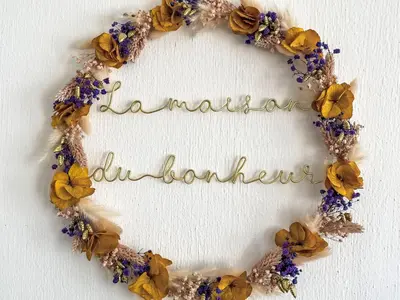 a wreath of flowers on a white wall at Holiday Home Villa Montagne by Interhome in Oppède