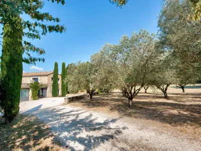 an estate with trees and a building in the background at Holiday Home Villa Montagne by Interhome in Oppède