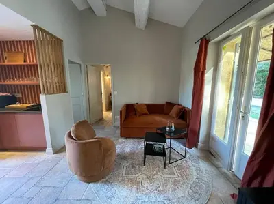 a living room with a couch and a table at Domaine Farandole in Eygalières