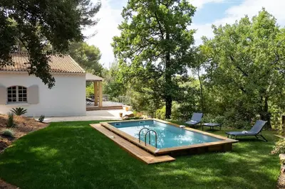 a swimming pool in the yard of a house at Villa La Pinède in Aix-en-Provence