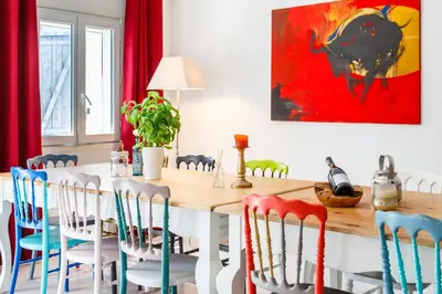 a dining room with a wooden table and chairs at Ritournelle en Provence 19 personnes 4 étoiles in Pernes-les-Fontaines