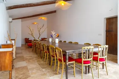 a dining room with a long table and chairs at Ritournelle en Provence 19 personnes 4 étoiles in Pernes-les-Fontaines