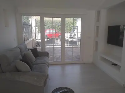 a living room with a couch and a sliding glass door at 2 Voyageurs - 1 Lit - Proche de toutes commodités in Peyrolles-en-Provence