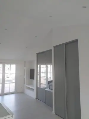 a white living room with glass wardrobes at 2 Voyageurs - 1 Lit - Proche de toutes commodités in Peyrolles-en-Provence