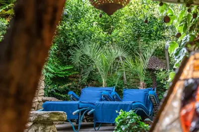 a group of blue chairs sitting on a patio at La maison de la piscine in Goult