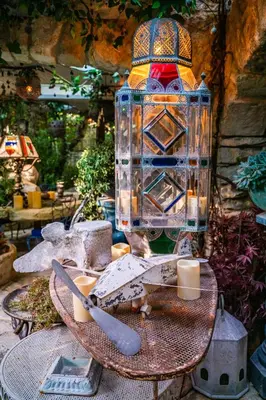 a glass jar with a candle on a table at La maison de la piscine in Goult