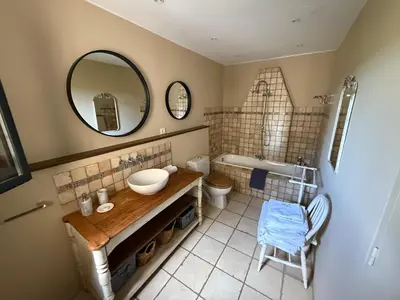a bedroom with a bed and a staircase at Moulin AURELIA in La Barben