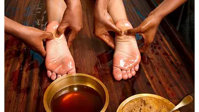 a person with their feet on a table with a bowl of tea at Nice flat with jacuzzi and garden in Velleron