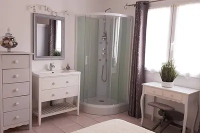 a bathroom with a shower and a sink and a desk at Nice flat with jacuzzi and garden in Velleron