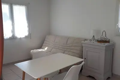 a living room with a couch and a table at Nice flat with jacuzzi and garden in Velleron
