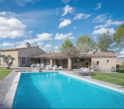 a bedroom with a bed and a balcony at villa avec piscine à Gordes, en Provence in Gordes