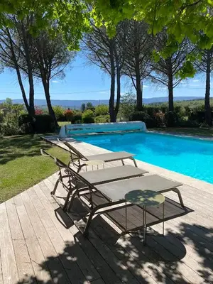 a bedroom with a large white bed with a window at villa avec piscine à Gordes, en Provence in Gordes