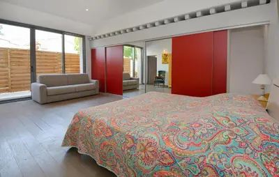a bedroom with a bed and a couch and windows at Stunning Home In Noves With Wifi in Noves