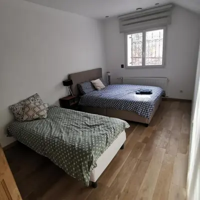 a bedroom with two beds and a window at Maison Aix en Provence et grand jardin in Aix-en-Provence
