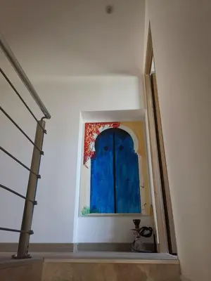 a blue door in a wall in a stair case at Maison Aix en Provence et grand jardin in Aix-en-Provence