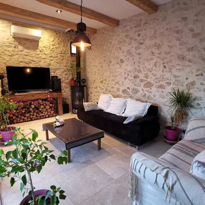 a living room with a couch and a table at Maison Aix en Provence et grand jardin in Aix-en-Provence