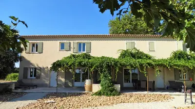 an exterior view of a building with trees at Gîte au coeur du vignoble des Saumanes in Châteauneuf-de-Gadagne