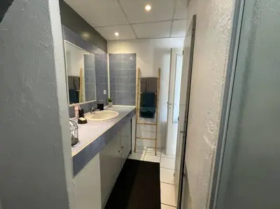 a bathroom with a sink and a mirror at Grand studio avec piscine au coeur du village in Le Puy-Sainte-Réparade