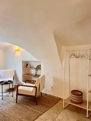 a living room with a chair and a table at coeur du Luberon in Lourmarin