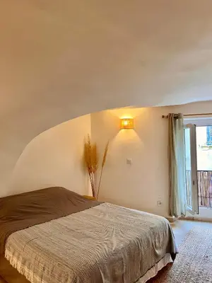 a bedroom with a bed and a window at coeur du Luberon in Lourmarin