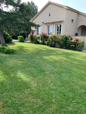 a patio with a table and chairs in a garden at Mas des Lubières in Saint-Rémy-de-Provence
