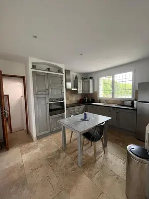 a kitchen with a table in the middle of it at Mas des Lubières in Saint-Rémy-de-Provence