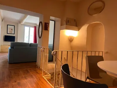 a living room with a couch and a table at Maison de ville avec rooftop vue sur le Ventoux in Monteux