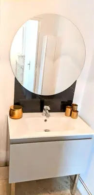 a bathroom sink with a mirror on top of it at Chambre Voltaire ou Chambre Beckett, terrasse en bord de Sorgue in Le Thor