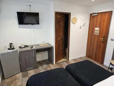 a room with a desk and a tv on the wall at La madone in La Tour-dʼAigues