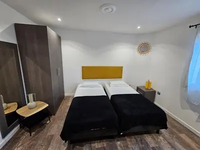 a bedroom with a large bed and a desk and a table at La madone in La Tour-dʼAigues