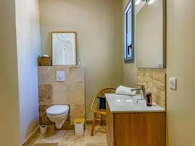a bathroom with a toilet and a sink at Villa Mathilde, un meublé de tourisme 3 étoiles au cœur de Goult in Goult