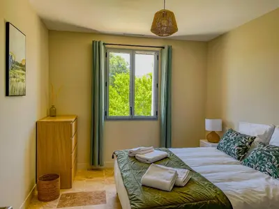 a bedroom with a bed and a window at Villa Mathilde, un meublé de tourisme 3 étoiles au cœur de Goult in Goult