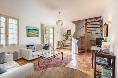 a living room with a couch and a table at La Maison des Roches in Gordes
