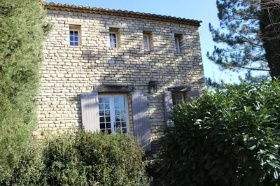 a brick building with windows on the side of it at La Maison des Roches in Gordes