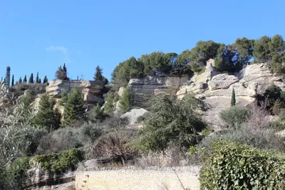 a rocky mountain with trees on top of it at La Maison des Roches in Gordes