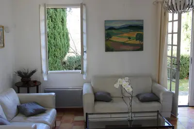 a living room with a couch and a table at La Maison des Roches in Gordes