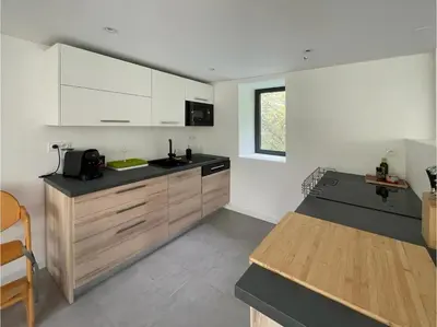 a kitchen with white cabinets and a counter top at Évasion Moderne en Provence in Lambesc
