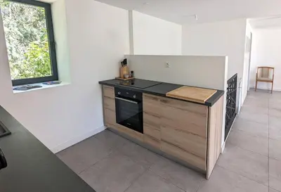 a kitchen with a stove and a counter top at Évasion Moderne en Provence in Lambesc