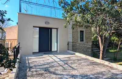 a house with a blue door and a tree at Évasion Moderne en Provence in Lambesc