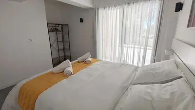 a bedroom with a large white bed with towels on it at Évasion Moderne en Provence in Lambesc